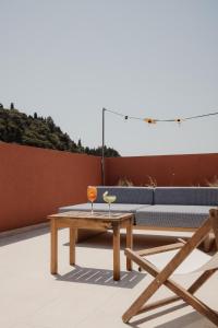 a coffee table and a couch on a patio at Aragosta Suites in Paleokastritsa +37 photos