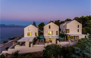 a house on the shore of the water at night at Villa Aster 3 in Sutivan