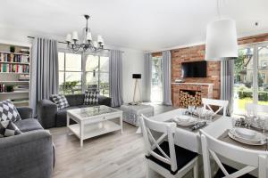 a living room with a couch and a table at Sopot Beach House in Sopot