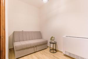 a couch sitting in a room next to a radiator at Archontiko Liamas in Stavros