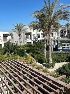 a group of palm trees in front of a building at ريفا فيو in El Alamein
