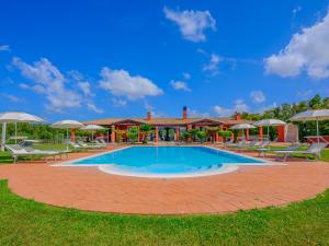 a pool with chairs and umbrellas in a yard at Villa Barbarina - Nature Resort with Pool & Restaurant - Alghero in Santa Maria la Palma +228 photos