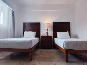 Postel nebo postele na pokoji v ubytování Hotel Suites Mar Elena