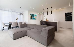 a living room and kitchen with a couch and a table at Lovely Apartment In Malinska With Wifi in Malinska