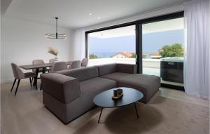 a living room with a couch and a table at Beautiful Apartment In Malinska in Malinska