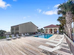 a deck with lounge chairs and a swimming pool at 136 La Valencia Cir - At Peace in Sunnyside