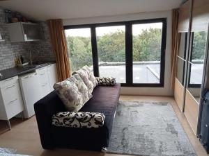 a living room with a couch and a large window at Tomorrowlandhome Boom in Boom