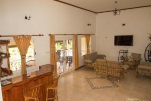 a living room with a table and chairs at Haus Megan in Mahe
