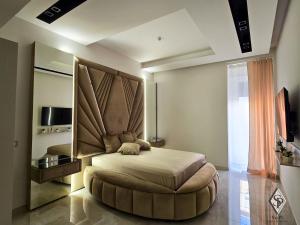 a bedroom with a large bed and a large mirror at SOPI Home in Castellammare di Stabia