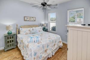 a bedroom with a bed and a ceiling fan at 5 Bed, 5 Bath Beach Home/Only a 3 Minute Walk To The Beach! SLEEPS 12 in Sunnyside +74 photos