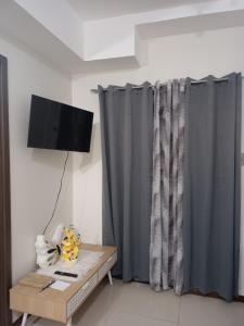 a living room with gray curtains and a table at Robinsons Galleria Tower 2 - Nice Place in Cebu City