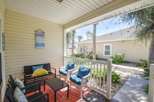 a screened porch with chairs and a fireplace at Palm Bay 305 in Corpus Christi