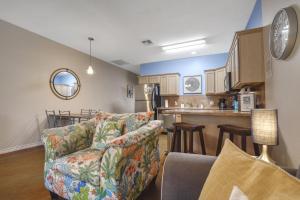 a living room with a couch and a kitchen at Palm Bay 305 in Corpus Christi