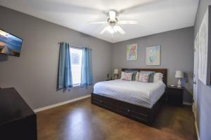 a bedroom with a bed and a ceiling fan at Palm Bay 305 in Corpus Christi +29 photos
