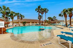 a pool at the resort with palm trees at Palm Bay 305 in Corpus Christi