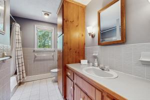 Un baño con lavabo, inodoro y espejo. en Jack's Dacha, en Dennis 20 fotos más