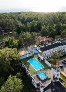 an aerial view of a swimming pool at a resort at APARTAMENT 8B BLUE MARINE Poddąbie Basen Odkryty Brodziki Plac Zabaw in Poddąbie