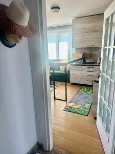 a living room with a green couch and a table at Complex Gallery Saint Thomas in Sozopol +26 photos