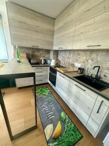 a kitchen with a sink and a kitchen rug on the floor at Complex Gallery Saint Thomas in Sozopol