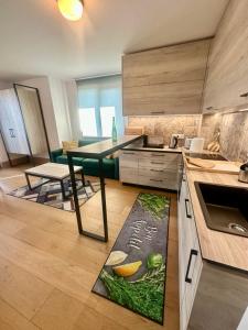 a kitchen with a table and a dining room at Complex Gallery Saint Thomas in Sozopol