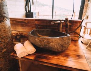 a bathroom with a stone sink on a wooden counter at Cabanyes entre Valls in Vall de Bianya