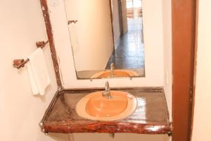 a bathroom with a sink and a mirror at Pousada Luz do Sol in Porto Seguro +70 photos