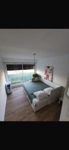 a bedroom with a large bed and a large window at Chambre chez nous! Au calme, Montolivet proche métro in Marseille