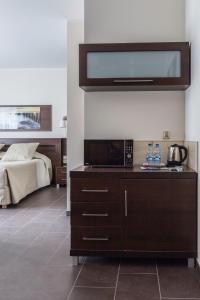 a kitchen with a microwave and a bed in a room at Villa Nova 34A in Hel