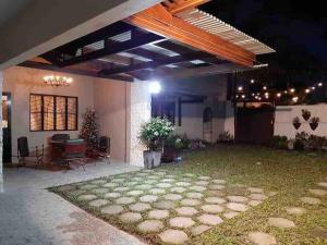 a patio of a house at night with a table at Fuji in Angeles