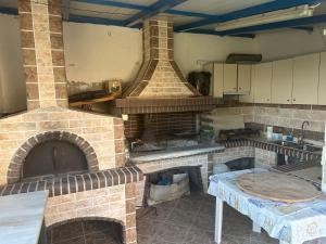 a large kitchen with a large brick oven at Sunnyhomes Vrachos in Vráchos