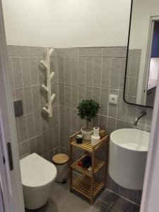 a bathroom with a white toilet and a sink at Casa Alegria in Oeiras +20 photos