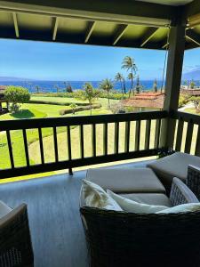 a balcony with a couch and a view of the ocean at Ocean Views from Every Room 3BD 3BA in Lahaina +17 photos