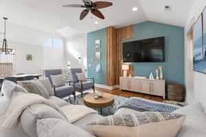 a living room with a couch and a tv at Work Trip in Kill Devil Hills