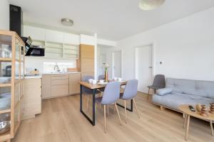 a kitchen and a living room with a table and chairs at Dorsza Green View Pogórze by Solarento in Pogórze