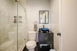 a bathroom with a toilet and a sink and a shower at Modern 3-Bdrm Apt in Black Rock in Bridgeport +14 photos