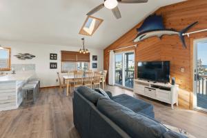 a living room with a couch and a shark head on the wall at Y-Worry in Kill Devil Hills
