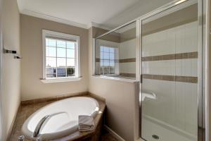 a bathroom with a bath tub and a shower at Summer Dayz - Families Love It Here, Just Across from the Beach in Panama City Beach +39 photos