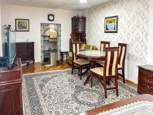 a living room with a dining room table and chairs at Bosnian House in Sarajevo +24 photos