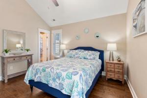 Un dormitorio con una cama con una colcha azul. en Zs Escape, en Kill Devil Hills