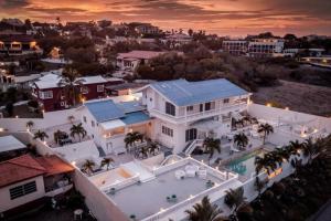 an aerial view of a house with a swimming pool at Group Accommodation Jan Thiel Curaçao in Willemstad