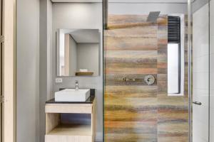 a bathroom with a sink and a mirror at Loft Home Suites 118 By gA in Bogotá +59 photos
