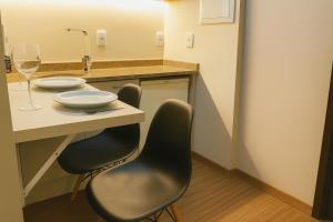 a kitchen with two chairs and a table with a sink at BOOK A FLAT Jardins São Paulo in São Paulo +24 photos