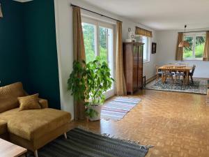a living room with a couch and a table at Villa Immergrün in Purgkirchen