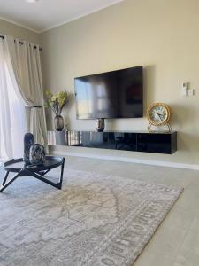 een woonkamer met een grote flatscreen-tv bij LLL Apartments M6 in Khakalashwe