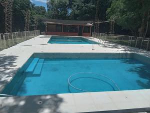 a large swimming pool with a pool at Refugios y Cabañas BAHIA in Puerto Iguazú