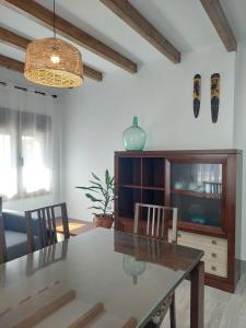 a dining table and chairs in a living room at El Rincón de San Fermín in Zizur Mayor