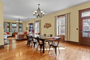 a dining room and living room with a table and chairs at The Marquis Manor | JZ Vacation Rentals in Soulard