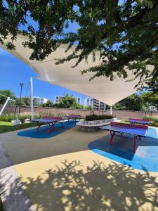 a group of ping pong tables under a white canopy at Casa Sayil in Alpuyeca