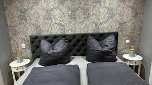 a bedroom with a bed with two pillows on it at Ferienwohnung Heideberg 2 in Kaisersesch