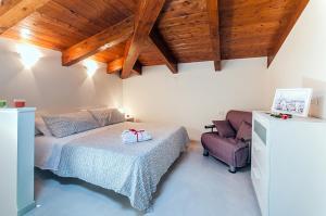 a bedroom with a bed and a chair at Casa Vacanza Diadema in Matera